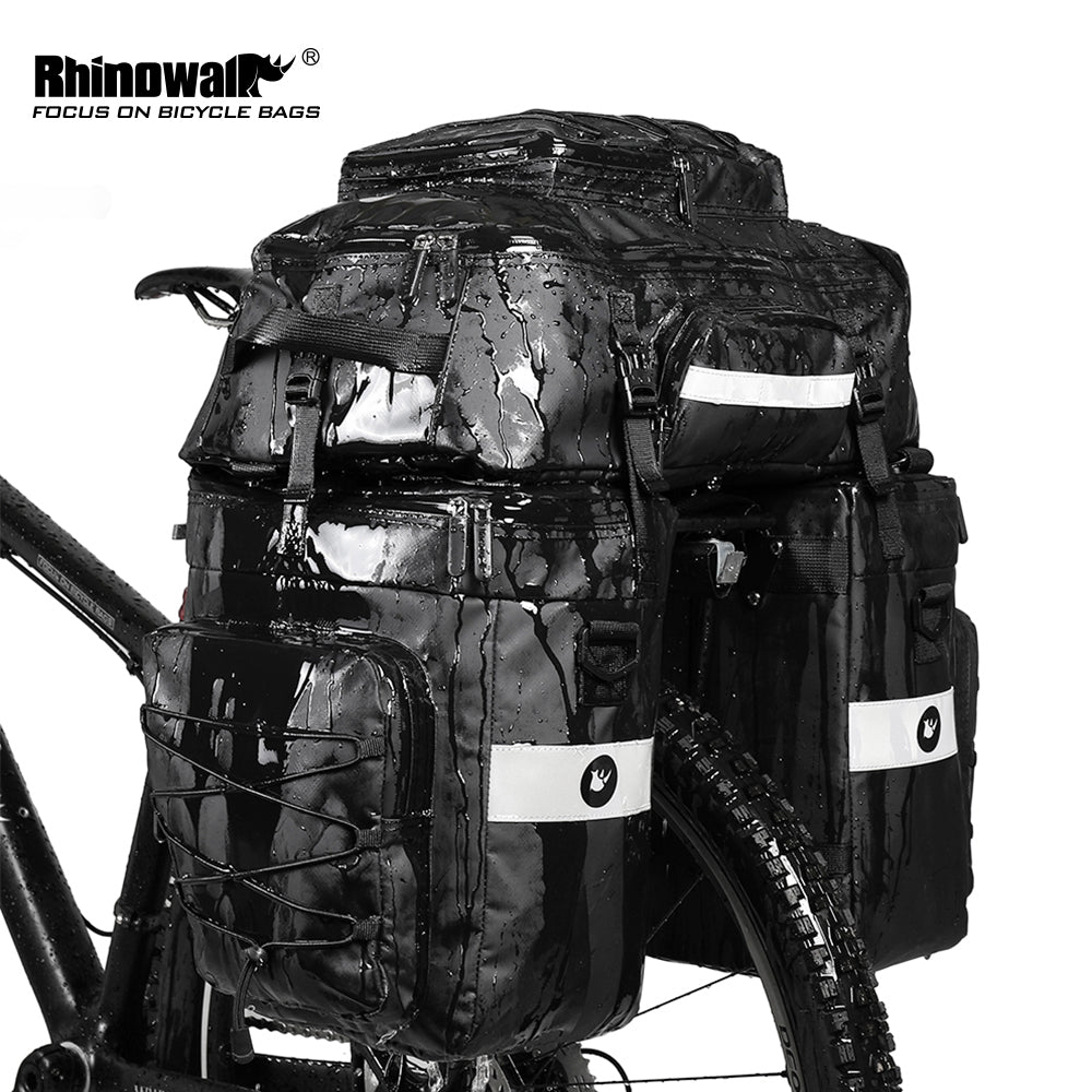 Bike Pannier Bag 3 in 1 Set 65L made by Rhinowalk. A 3 in 1 multifunctional bike rear pannier bag - 2 x one side shoulder bags and 1x backpack that can be used independently. Quick release system, easy to be fixed on rear seat trunk rack. Made of 1000D polyester material with waterproof PVC layer.