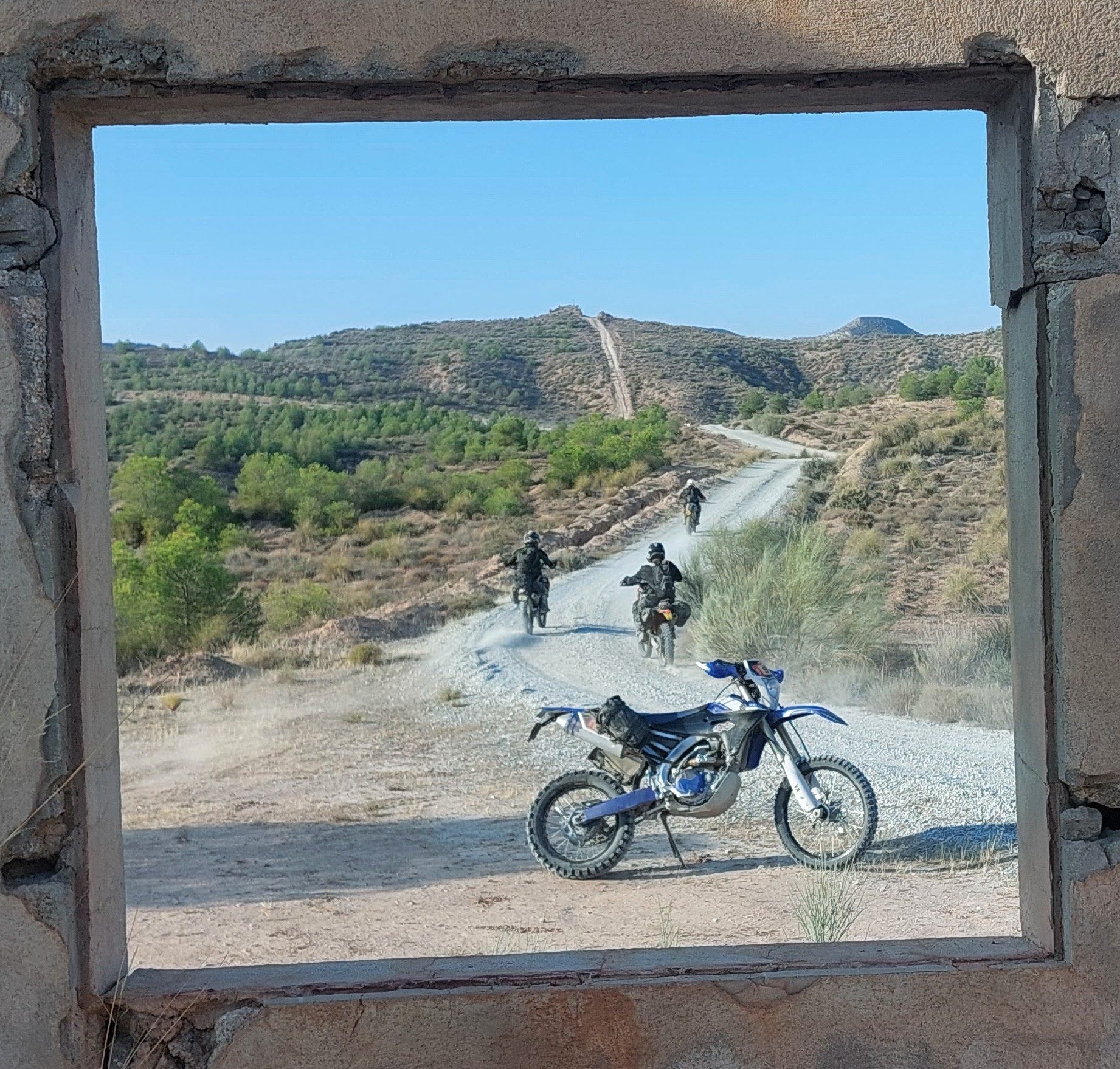 View of motorcycles riding off into the distance towards the mountain